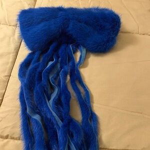 A Genuine Mink Bow attached to the front of the collar.